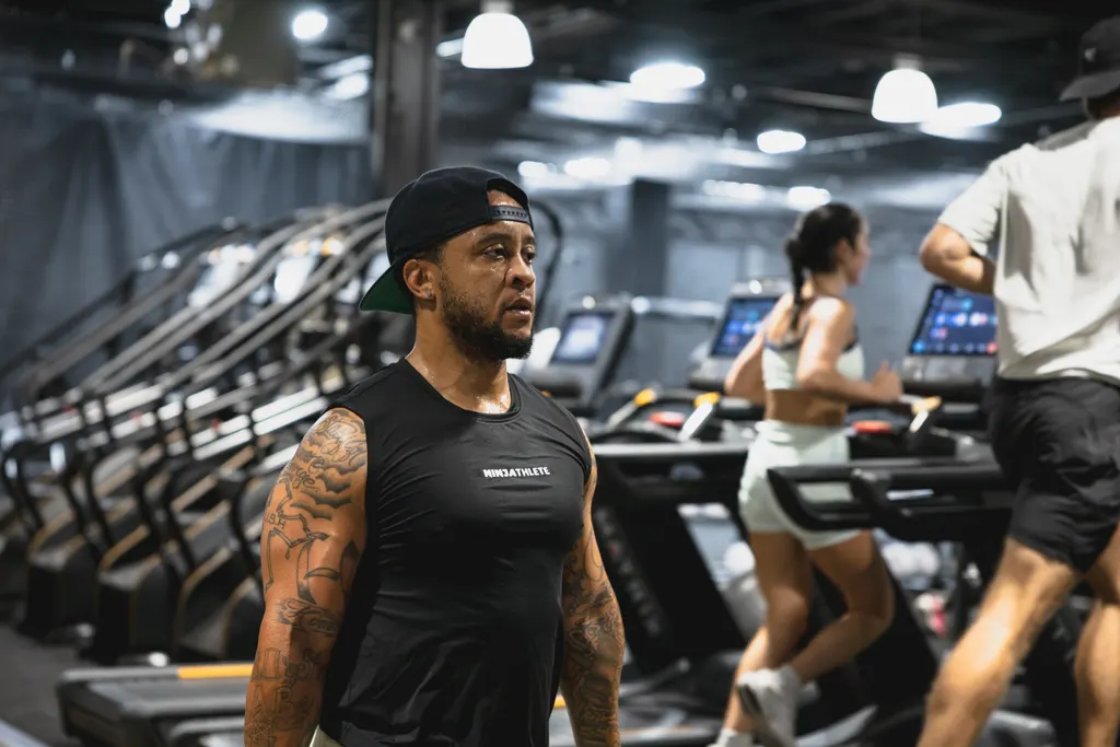 Members running on the row of Matrix treadmills on the DPS cardio deck