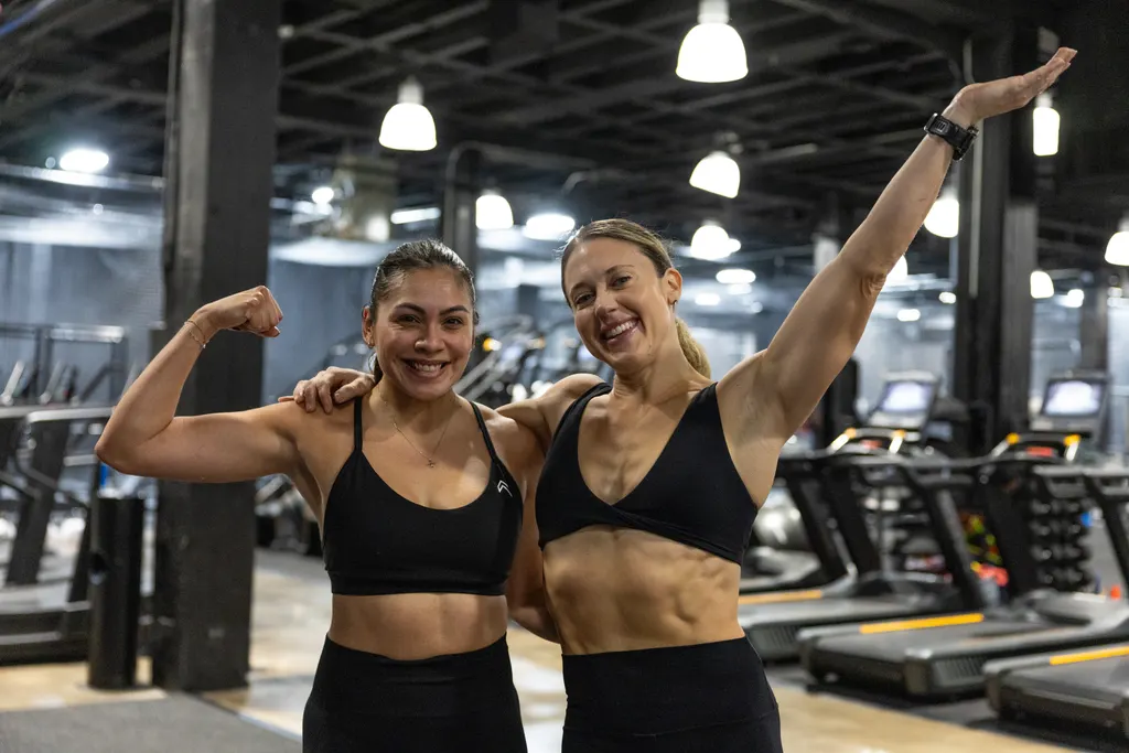 Two members flexing and celebrating after a workout at DPS