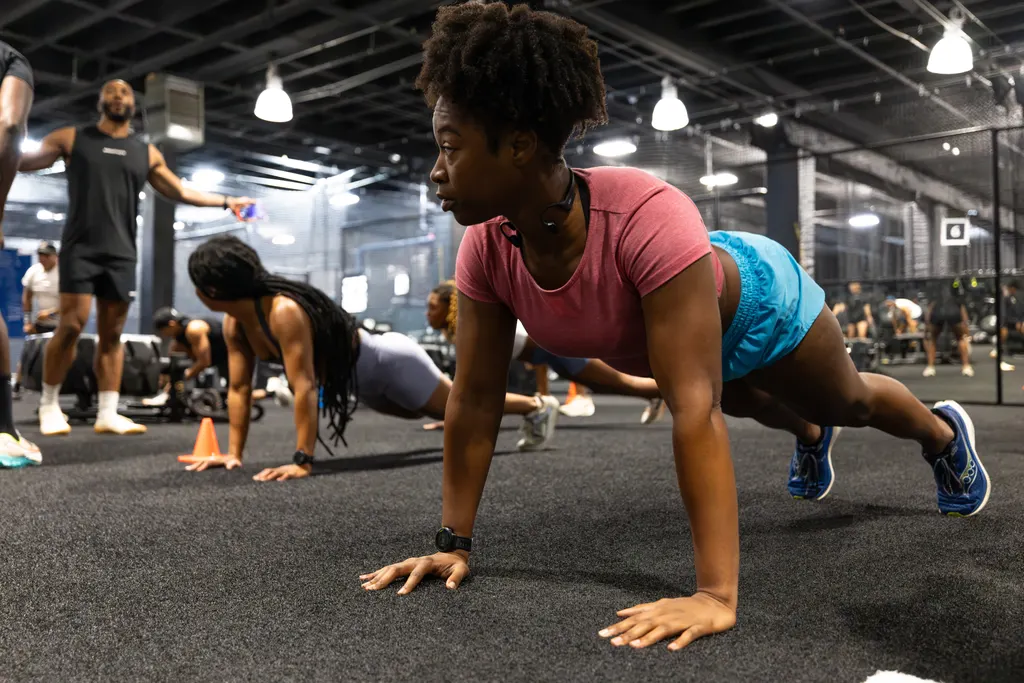 Group class doing push-ups on the turf training floor at DPS