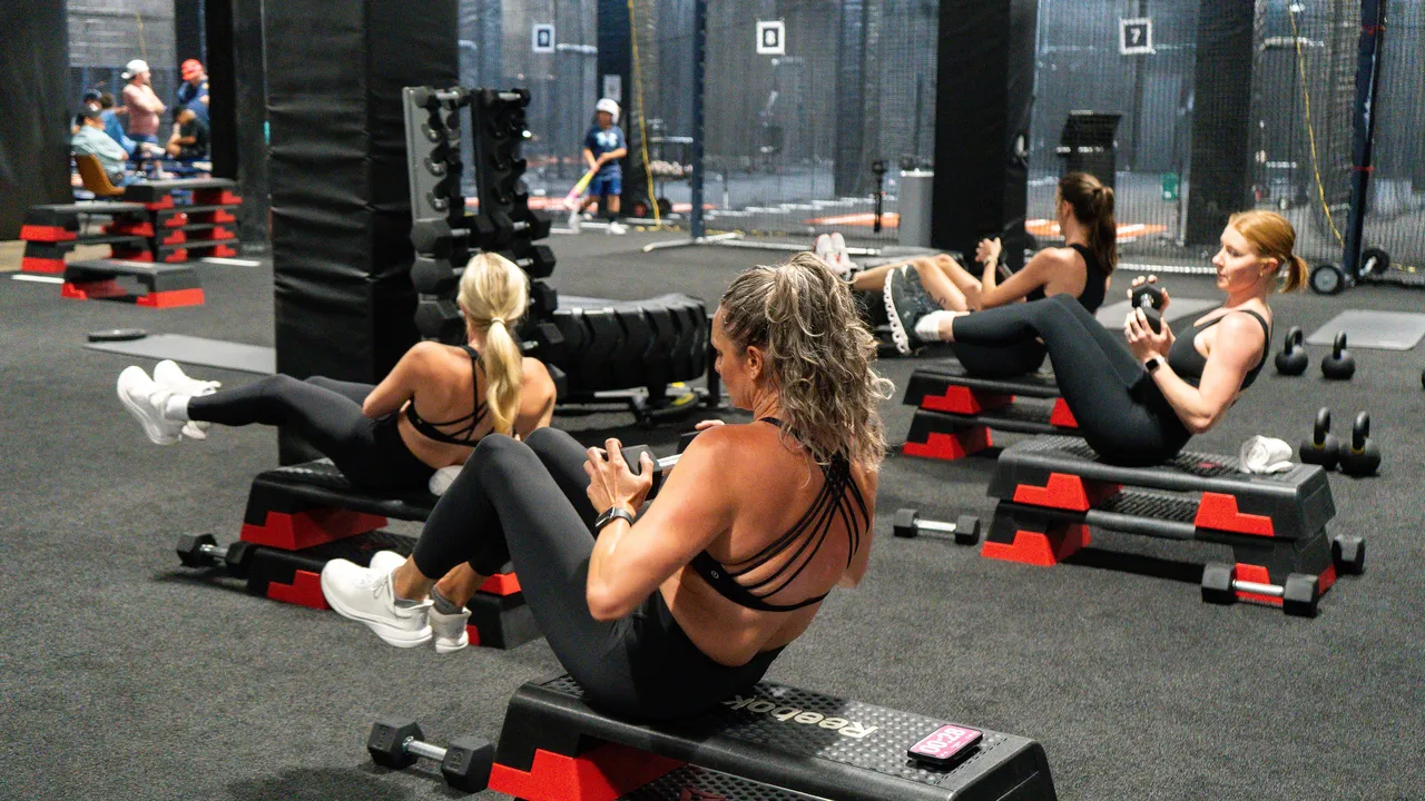 Group fitness class doing coached core work at Dallas Performance Systems